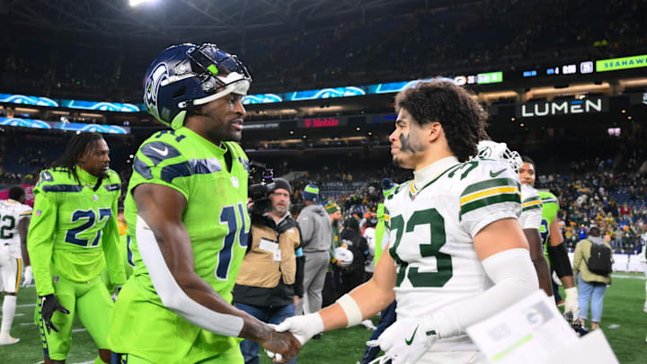 Dec 15, 2024; Seattle, Washington, USA; Seattle Seahawks wide receiver DK Metcalf (14) and Green Bay Packers safety Evan Williams (33) shake hands after the game at Lumen Field. Mandatory Credit: Steven Bisig-Imagn Images