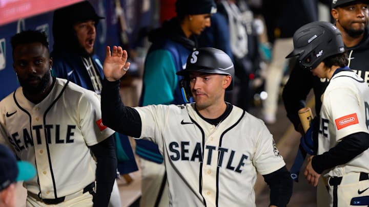 Mar 29, 2026; Seattle, Washington, USA; Seattle Mariners designated hitter Dominic Canzone (8) celebrates in the dugout after scoring a run against the Cleveland Guardians during the fourth inning at T-Mobile Park. Mandatory Credit: Steven Bisig-Imagn Images