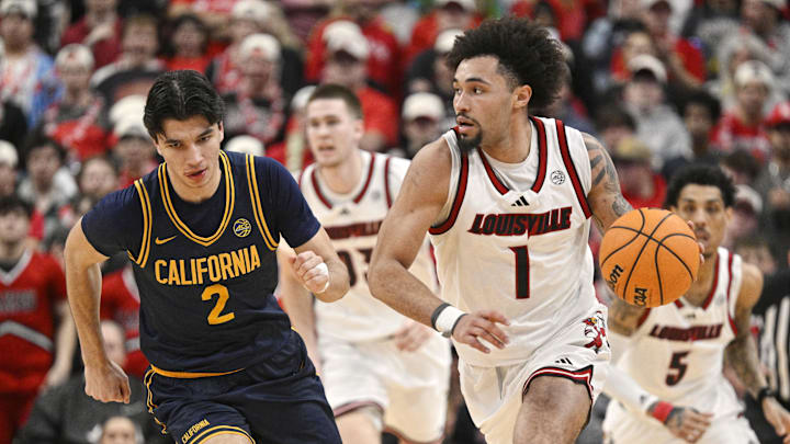 Mar 5, 2025; Louisville, Kentucky, USA;  Louisville Cardinals guard J'Vonne Hadley (1) dribbles against California Golden Bears guard Andrej Stojakovic (2) during the second half at KFC Yum! Center. Louisville defeated California 85-68. Mandatory Credit: Jamie Rhodes-Imagn Images