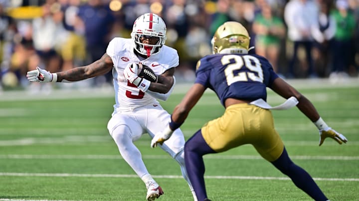 Oct 12, 2024; South Bend, Indiana, USA; Stanford Cardinal running back Chris Davis Jr. (5) runs the ball as Notre Dame Fighting Irish cornerback Christian Gray (29) defends in the first quarter at Notre Dame Stadium. Mandatory Credit: Matt Cashore-Imagn Images