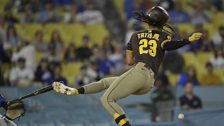 Jun 19, 2025; Los Angeles, California, USA;   San Diego Padres right fielder Fernando Tatis Jr. (23) reacts as he is hit by a pitch in the eighth inning against the Los Angeles Dodgers at Dodger Stadium. Mandatory Credit: Jayne Kamin-Oncea-Imagn Images