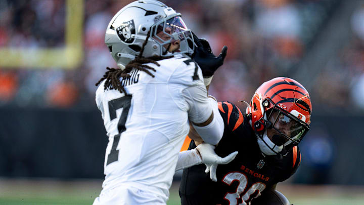 Las Vegas Raiders safety Tre’von Moehrig (7) tackles Cincinnati Bengals halfback Chase Brown (30) in the fourth quarter of the NFL game at Paycor Stadium in Cincinnati on Sunday, Nov. 3, 2024.