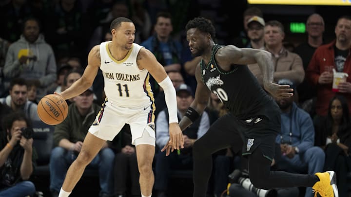 Feb 6, 2026; Minneapolis, Minnesota, USA; New Orleans Pelicans guard Bryce McGowens (11) holds the ball and looks to pass as Minnesota Timberwolves forward Julius Randle (30) plays defense in the second half at Target Center. Mandatory Credit: Jesse Johnson-Imagn Images