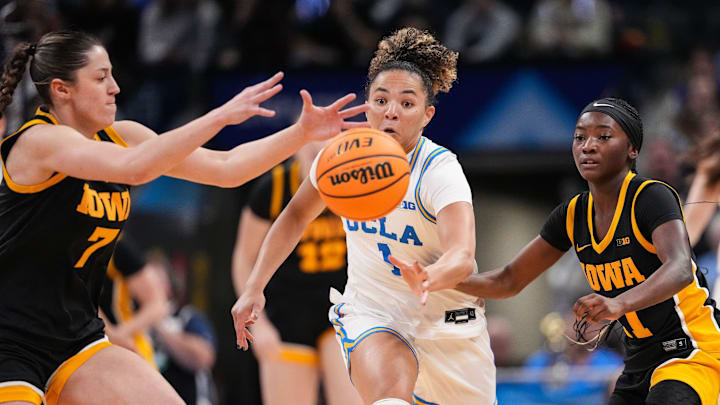 UCLA Bruins guard Kiki Rice (1) reaches for the ball against Iowa Hawkeyes guard Chazadi Wright (11) on Sunday, March 8, 2026, during the Big Ten Tournament Championship game at Gainbridge Fieldhouse in Indianapolis. UCLA Bruins defeated the Iowa Hawkeyes, 96-45, for back to back Big Ten championships. UCLA Bruins guard Kiki Rice (1) reaches for the ball against Iowa Hawkeyes guard Chazadi Wright (11) on Sunday, March 8, 2026, during the Big Ten Tournament Championship game at Gainbridge Fieldhouse in Indianapolis. UCLA Bruins defeated the Iowa Hawkeyes, 96-45, for back to back Big Ten championships.