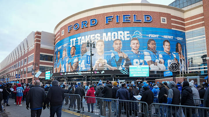 Football fans line up outside of Gate A of Ford Field.