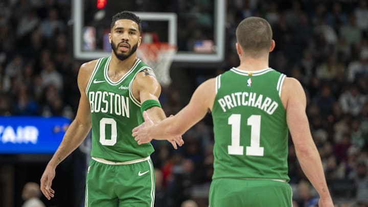 Jan 2, 2025; Minneapolis, Minnesota, USA; Boston Celtics forward Jayson Tatum (0) celebrates with guard Payton Pritchard (11) after making a shot against the Minnesota Timberwolves in the first half at Target Center. Mandatory Credit: Jesse Johnson-Imagn Images