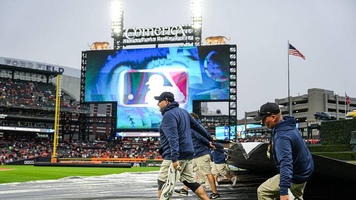 The Detroit Tigers' grounds crew removes the tarp from the field after the rain delay. The Detroit Tigers' grounds crew removes the tarp from the field after the rain delay.
