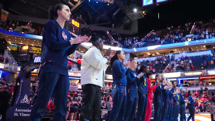 Indiana Fever guard Caitlin Clark (22) stands with the team during the national anthem on Thursday,