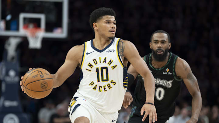 Oct 26, 2025; Minneapolis, Minnesota, USA; Indiana Pacers guard RayJ Dennis (10) dribbles the ball as Minnesota Timberwolves guard Mike Conley (10) plays defense in the second half at Target Center. Mandatory Credit: Jesse Johnson-Imagn Images