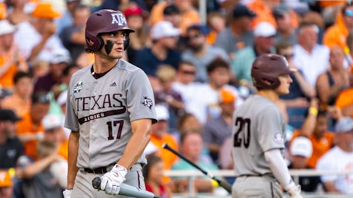Texas A&M Aggies right fielder Jace Laviolette (17) walks off as catcher Jackson Appel (20) walks up to bat during the sixth inning against the Tennessee Volunteers at Charles Schwab Field Omaha.