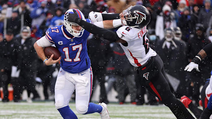 Bills quarterback Josh Allen fights off a tackle by Falcons Donte Fowler Jr.