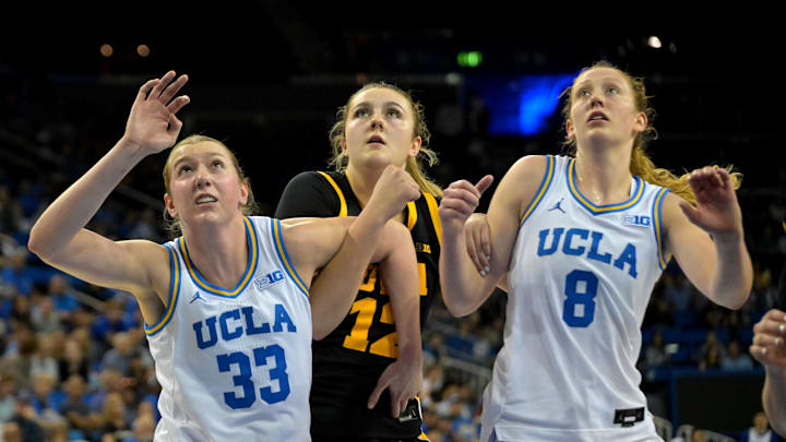 UCLA Bruins forward Amanda Muse and guard Gianna Kneepkens box out Iowa Hawkeyes center Layla Hays