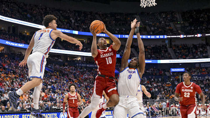 Mar 15, 2025; Nashville, TN, USA; Alabama Crimson Tide forward Mouhamed Dioubate (10) shoots between Florida Gators guard Walter Clayton Jr. (1) and center Rueben Chinyelu (9) during the first half at Bridgestone Arena. Mar 15, 2025; Nashville, TN, USA; Alabama Crimson Tide forward Mouhamed Dioubate (10) shoots between Florida Gators guard Walter Clayton Jr. (1) and center Rueben Chinyelu (9) during the first half at Bridgestone Arena.