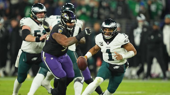 Philadelphia Eagles quarterback Jalen Hurts avoids third quarter pressure from Baltimore Ravens linebacker Tavius Robinson