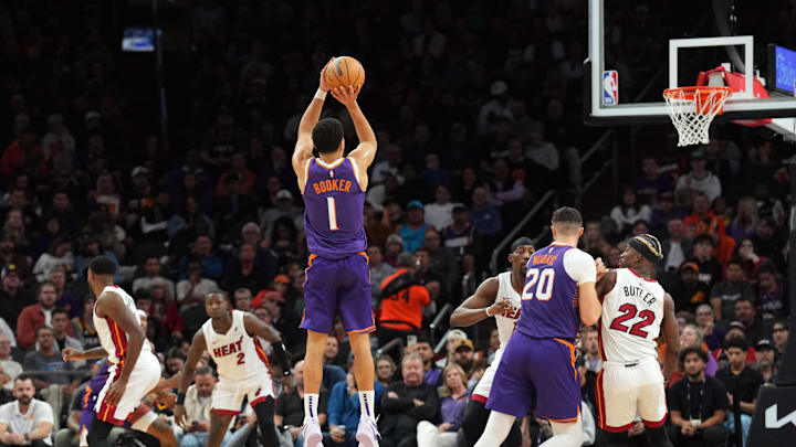 Nov 6, 2024; Phoenix, Arizona, USA; Phoenix Suns guard Devin Booker (1) shoots against the Miami Heat during the second half at Footprint Center. Mandatory Credit: Joe Camporeale-Imagn Images