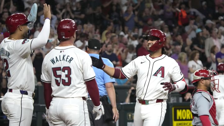 Apr 12, 2024; Phoenix, Arizona, USA; Arizona Diamondbacks third baseman Eugenio Suarez celebrates with left fielder Lourdes Gurriel Jr. and first baseman Christian Walker after hitting a two run home run against the St. Louis Cardinals in the fifth inning at Chase Field. Mandatory Credit: Rick Scuteri-USA TODAY Sports Apr 12, 2024; Phoenix, Arizona, USA; Arizona Diamondbacks third baseman Eugenio Suarez celebrates with left fielder Lourdes Gurriel Jr. and first baseman Christian Walker after hitting a two run home run against the St. Louis Cardinals in the fifth inning at Chase Field. Mandatory Credit: Rick Scuteri-USA TODAY Sports