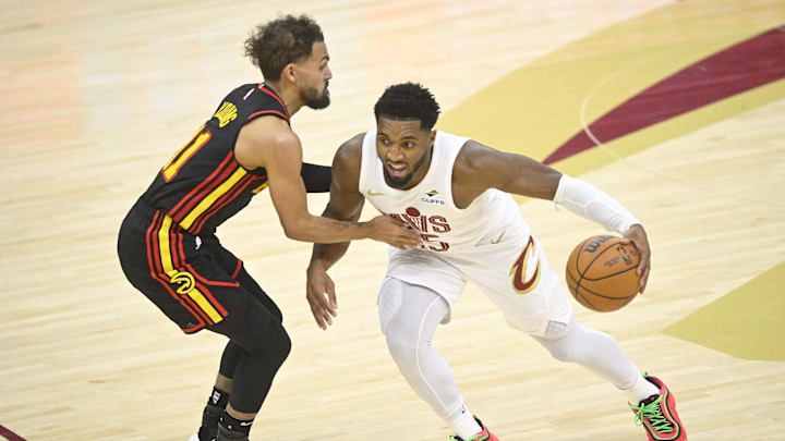Nov 27, 2024; Cleveland, Ohio, USA; Cleveland Cavaliers guard Donovan Mitchell (45) brings the ball up court beside Atlanta Hawks guard Trae Young (11) in the fourth quarter at Rocket Mortgage FieldHouse. Mandatory Credit: David Richard-Imagn Images