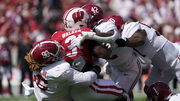 Sep 14, 2024; Madison, Wisconsin, USA;  Wisconsin Badgers running back Tawee Walker (3) is tackled by Alabama Crimson Tide defensive lineman Tim Keenan III (96) during the second quarter at Camp Randall Stadium. Mandatory Credit: Jeff Hanisch-Imagn Images