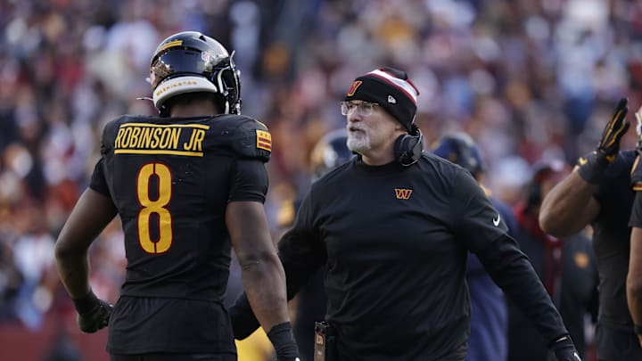 Dec 1, 2024; Landover, Maryland, USA; Washington Commanders head coach Dan Quinn (center) celebrates with Commanders running back Brian Robinson Jr. (8) after a touchdown against Tennessee Titans during the first half at Northwest Stadium. Mandatory Credit: Amber Searls-Imagn Images Dec 1, 2024; Landover, Maryland, USA; Washington Commanders head coach Dan Quinn (center) celebrates with Commanders running back Brian Robinson Jr. (8) after a touchdown against Tennessee Titans during the first half at Northwest Stadium. Mandatory Credit: Amber Searls-Imagn Images