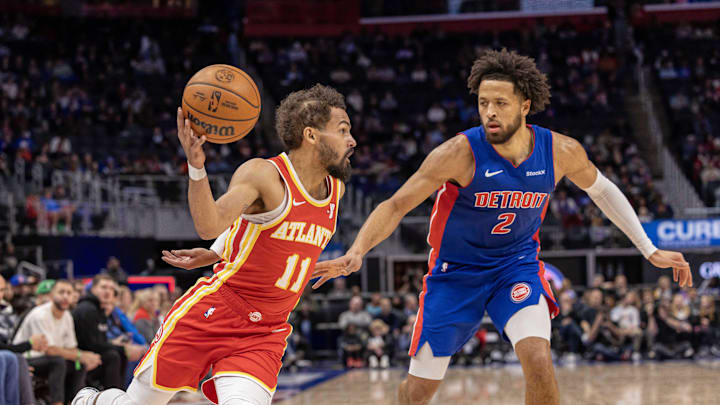 Nov 8, 2024; Detroit, Michigan, USA; Atlanta Hawks guard Trae Young (11) moves the ball up court next to Detroit Pistons guard Cade Cunningham (2) during the first half at Little Caesars Arena. Mandatory Credit: David Reginek-Imagn Images