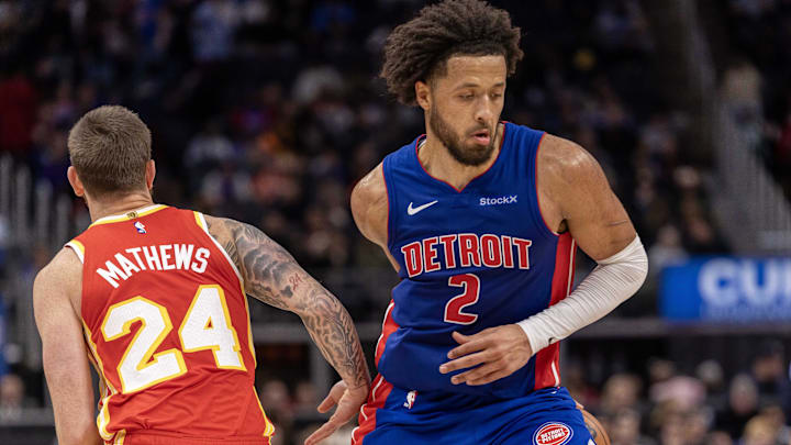 Nov 8, 2024; Detroit, Michigan, USA; Detroit Pistons guard Cade Cunningham (2) makes a behind the back move to avoid the pressure from Atlanta Hawks guard Garrison Mathews (24) during the second half at Little Caesars Arena. Mandatory Credit: David Reginek-Imagn Images