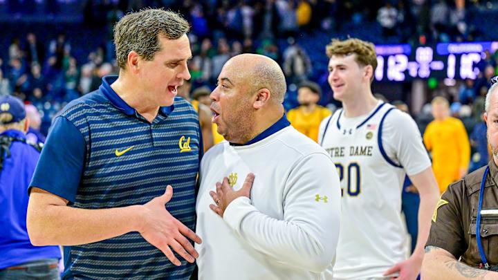 Cal coach Mark Madsen, left, visits with Notre Dame coach Micah Shrewsberry after the Irish beat the Bears 112-110 in four overtimes. Cal coach Mark Madsen, left, visits with Notre Dame coach Micah Shrewsberry after the Irish beat the Bears 112-110 in four overtimes.