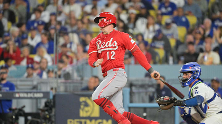 Sep 30, 2025; Los Angeles, California, USA; Cincinnati Reds left fielder Austin Hays (12) hits a single during the seventh inning against the Los Angeles Dodgers during game one of the Wildcard round for the 2025 MLB playoffs at Dodger Stadium. Mandatory Credit: Jayne Kamin-Oncea-Imagn Images Sep 30, 2025; Los Angeles, California, USA; Cincinnati Reds left fielder Austin Hays (12) hits a single during the seventh inning against the Los Angeles Dodgers during game one of the Wildcard round for the 2025 MLB playoffs at Dodger Stadium. Mandatory Credit: Jayne Kamin-Oncea-Imagn Images