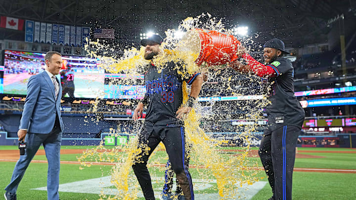 May 2, 2025; Toronto, Ontario, CAN; Toronto Blue Jays first base Vladimir Guerrero Jr. (27) pours the ice bucket on  pinch hitter and centre fielder Nathan Lukes (38) against the Cleveland Guardians at the end of the ninth inning at Rogers Centre. Mandatory Credit: Nick Turchiaro-Imagn Images