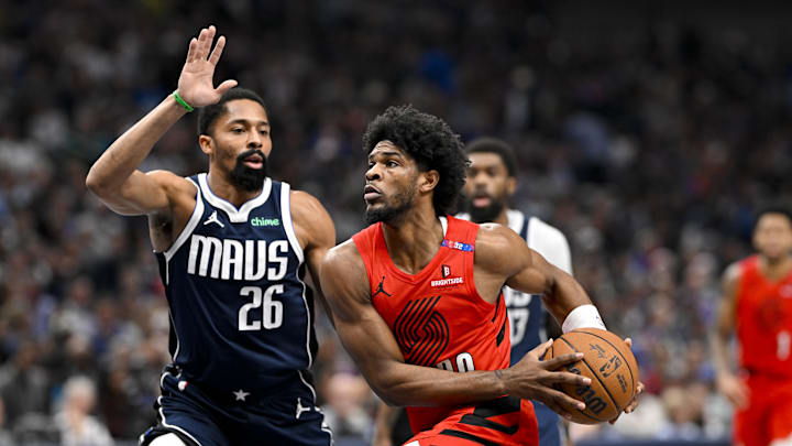 Dec 23, 2024; Dallas, Texas, USA; Portland Trail Blazers guard Scoot Henderson (00) drives to the basket past Dallas Mavericks guard Spencer Dinwiddie (26) during the second quarter at the American Airlines Center. Mandatory Credit: Jerome Miron-Imagn Images Dec 23, 2024; Dallas, Texas, USA; Portland Trail Blazers guard Scoot Henderson (00) drives to the basket past Dallas Mavericks guard Spencer Dinwiddie (26) during the second quarter at the American Airlines Center. Mandatory Credit: Jerome Miron-Imagn Images