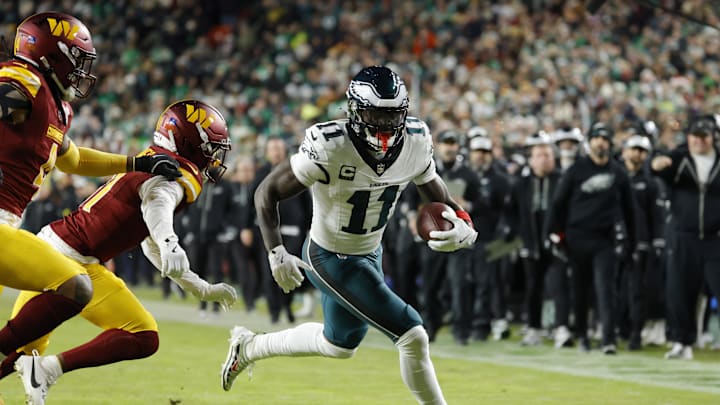Dec 20, 2025; Landover, Maryland, USA; Philadelphia Eagles wide receiver A.J. Brown (11) carries the ball as Washington Commanders cornerback Jonathan Jones (31) defends during the first half at Northwest Stadium. 