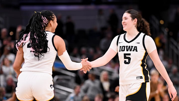Mar 7, 2026; Indianapolis, IN, USA; Iowa Hawkeyes forward Hannah Stuelke (45) and Iowa Hawkeyes center Ava Heiden (5) high-five against the Michigan Wolverines during the second half at Gainbridge Fieldhouse. Mandatory Credit: Robert Goddin-Imagn Images
