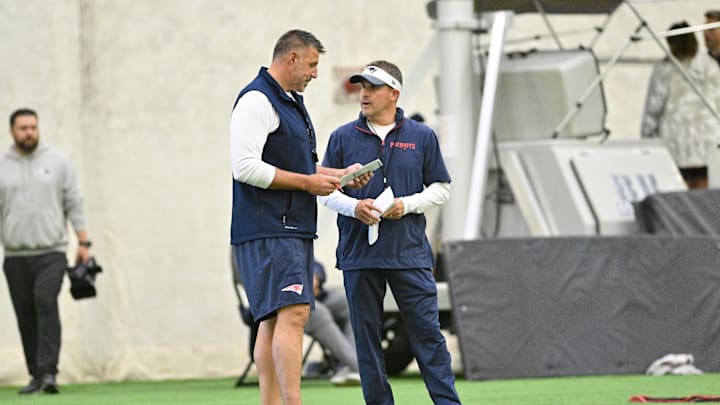 Jun 10, 2025; Foxborough, MA, USA; New England Patriots head coach Mike Vrabel (l) and offensive coordinator Josh McDaniels (r) speak to each other during minicamp held in the WIN Field House at Gillette Stadium. Mandatory Credit: Eric Canha-Imagn Images