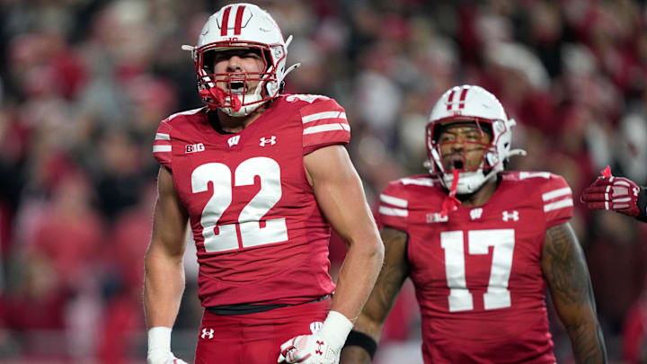 Nov 22, 2025; Madison, Wisconsin, USA; Wisconsin Badgers linebacker Mason Reiger (22) reacts with teammate Wisconsin Badgers linebacker Darryl Peterson (17) to sacking Illinois Fighting Illini quarterback Luke Altmyer (not pictured) during the second quarter at Camp Randall Stadium. Mandatory Credit: Kayla Wolf-Imagn Images