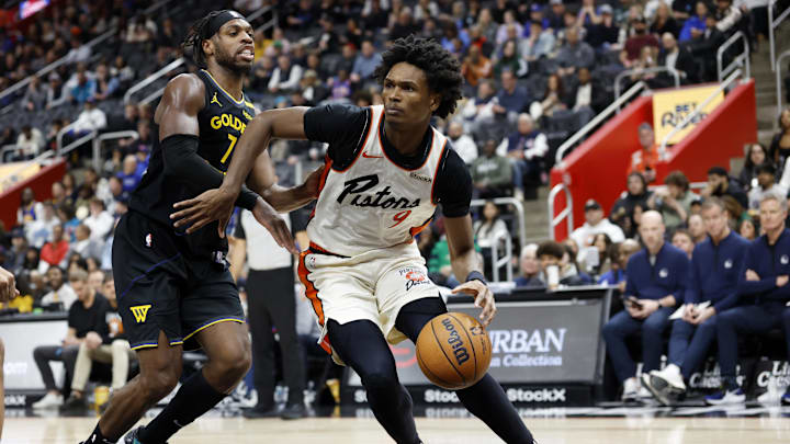 Jan 9, 2025; Detroit, Michigan, USA;  Detroit Pistons forward Ausar Thompson (9) dribbles defended by Golden State Warriors guard Buddy Hield (7) in the first half at Little Caesars Arena. Mandatory Credit: Rick Osentoski-Imagn Images