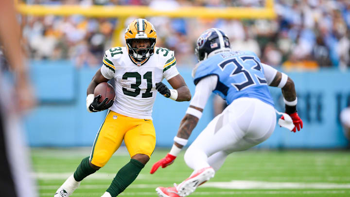 Sep 22, 2024; Nashville, Tennessee, USA;  Tennessee Titans safety Jamal Adams (33) tackles Green Bay Packers running back Emanuel Wilson (31) during the first half at Nissan Stadium. Mandatory Credit: Steve Roberts-Imagn Images