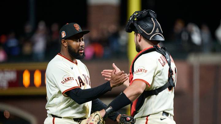 San Francisco Giants pitcher Dylan Smith (66) celebrates with catcher Drew Cavanaugh (61).