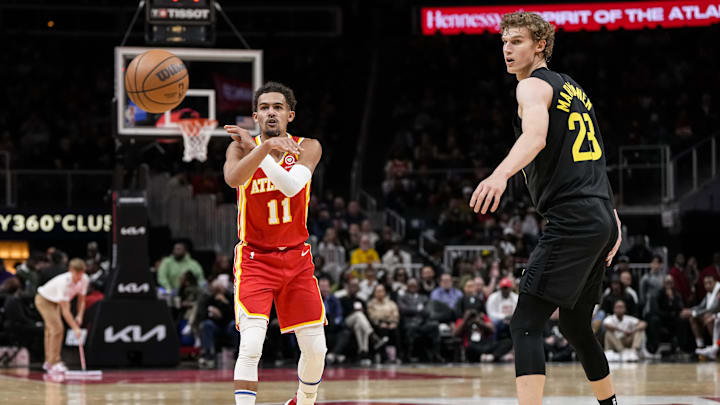 Nov 9, 2022; Atlanta, Georgia, USA; Atlanta Hawks guard Trae Young (11) passes the ball past Utah Jazz forward Lauri Markkanen (23) during the first quarter at State Farm Arena. Mandatory Credit: Dale Zanine-Imagn Images