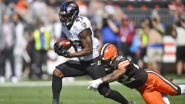 Oct 1, 2023; Cleveland, Ohio, USA; Baltimore Ravens running back Justice Hill (43) runs with the ball beside Cleveland Browns safety Grant Delpit (22) in the second quarter at Cleveland Browns Stadium. Mandatory Credit: David Richard-Imagn Images