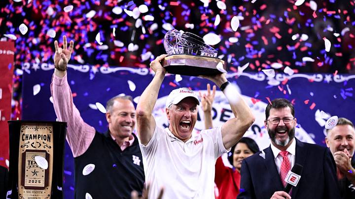 Dec 27, 2025; Houston, TX, USA; Houston Cougars head coach Willie Fritz hoists the champions trophy after the win over Louisiana State Tigers at NRG Stadium. Mandatory Credit: Maria Lysaker-Imagn Images Dec 27, 2025; Houston, TX, USA; Houston Cougars head coach Willie Fritz hoists the champions trophy after the win over Louisiana State Tigers at NRG Stadium. Mandatory Credit: Maria Lysaker-Imagn Images