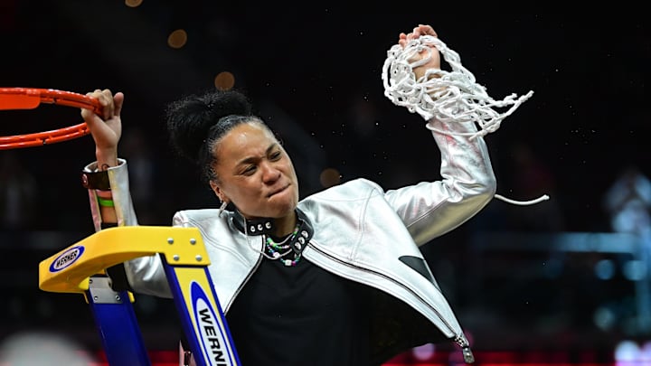Apr 7, 2024; Cleveland, OH, USA; South Carolina Gamecocks head coach Dawn Staley cuts the net after defeating the Iowa Hawkeyes in the finals of the Final Four of the womens 2024 NCAA Tournament  at Rocket Mortgage FieldHouse. Mandatory Credit: Ken Blaze-Imagn Images