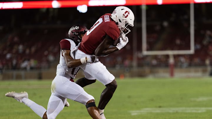 Sep 3, 2022; Stanford, California, USA; Stanford Cardinal wide receiver Mudia Reuben (0) catches the ball for a touchdown during the fourth quarter against Colgate Raiders defensive back Taitwoine Sanders (17) at Stanford Stadium. Mandatory Credit: Stan Szeto-Imagn Images Sep 3, 2022; Stanford, California, USA; Stanford Cardinal wide receiver Mudia Reuben (0) catches the ball for a touchdown during the fourth quarter against Colgate Raiders defensive back Taitwoine Sanders (17) at Stanford Stadium. Mandatory Credit: Stan Szeto-Imagn Images