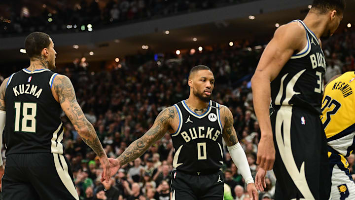 Apr 27, 2025; Milwaukee, Wisconsin, USA; Milwaukee Bucks guard Damian Lillard (0) reacts with forward Kyle Kuzma (18) in the first quarter against the Indiana Pacers during game four of first round for the 2024 NBA Playoffs at Fiserv Forum. Lillard left the game early in the in the first quarter with an injury. Mandatory Credit: Benny Sieu-Imagn Images
