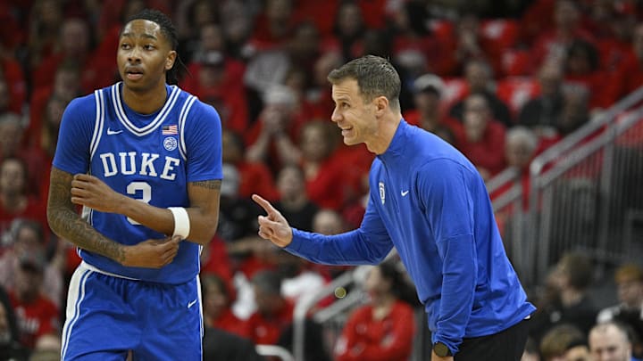 Jan 6, 2026; Louisville, Kentucky, USA; Duke Blue Devils head coach Jon Scheyer talks with Duke Blue Devils guard Isaiah Evans (3) during the first half against the Louisville Cardinals at KFC Yum! Center. Duke defeated Louisville 84-73. Mandatory Credit: Jamie Rhodes-Imagn Images Jan 6, 2026; Louisville, Kentucky, USA; Duke Blue Devils head coach Jon Scheyer talks with Duke Blue Devils guard Isaiah Evans (3) during the first half against the Louisville Cardinals at KFC Yum! Center. Duke defeated Louisville 84-73. Mandatory Credit: Jamie Rhodes-Imagn Images