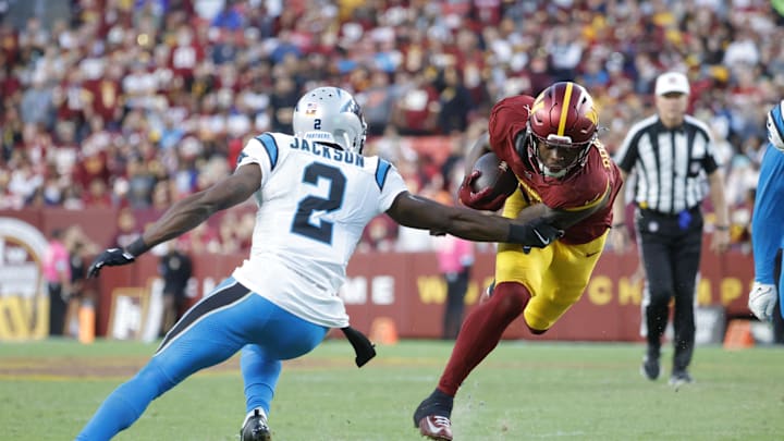 Oct 20, 2024; Landover, Maryland, USA; Washington Commanders running back Brian Robinson Jr. (8) carries the ball as Carolina Panthers cornerback Michael Jackson (2) defends during the second half at Northwest Stadium. Mandatory Credit: Amber Searls-Imagn Images Oct 20, 2024; Landover, Maryland, USA; Washington Commanders running back Brian Robinson Jr. (8) carries the ball as Carolina Panthers cornerback Michael Jackson (2) defends during the second half at Northwest Stadium. Mandatory Credit: Amber Searls-Imagn Images