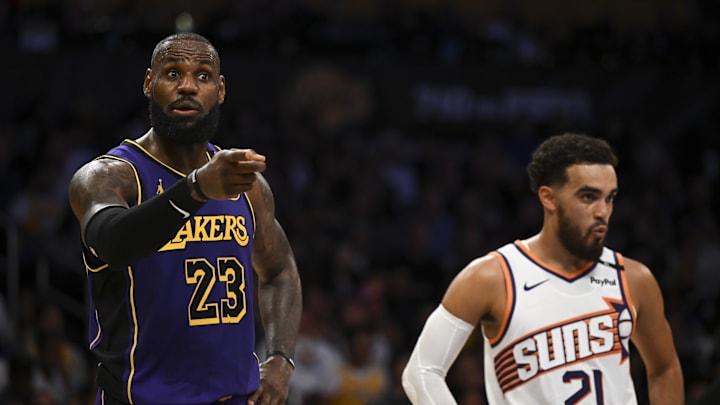 Oct 25, 2024; Los Angeles, California, USA; Los Angeles Lakers forward LeBron James (23) reacts against Phoenix Suns guard Tyus Jones (21) during the second half at Crypto.com Arena. Mandatory Credit: Jonathan Hui-Imagn Images