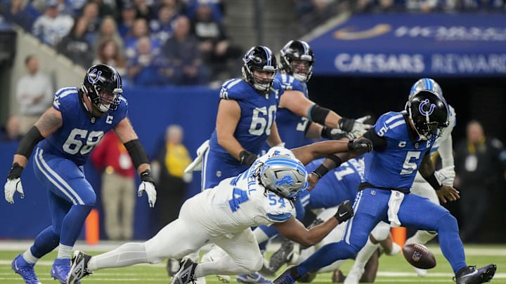 Nov 24, 2024; Indianapolis, Indiana, USA; Detroit Lions defensive tackle Alim McNeill (54) causes Indianapolis Colts quarterback Anthony Richardson (5) to fumble the ball during a game against the Detroit Lions  at Lucas Oil Stadium. Mandatory Credit: Christine Tannous/USA TODAY Network via Imagn Images