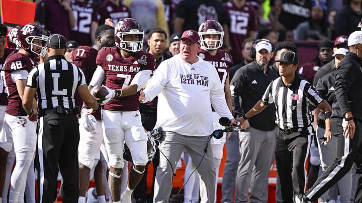 Dec 20, 2025; College Station, TX, USA; Texas A&M Aggies head coach Mike Elko reacts to a call during the game between the Aggies and the Hurricanes at Kyle Field. Mandatory Credit: Jerome Miron-Imagn Images