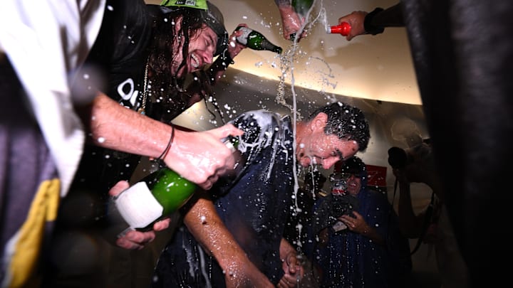Oct 2, 2022; San Diego, California, USA; San Diego Padres president and general manager AJ Preller celebrates in the clubhouse following the game against the Chicago White Sox after clinching a playoff berth at Petco Park. 