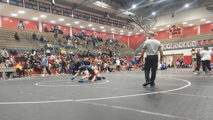A Georgia high school wrestler suffered a broken neck during Thursday's quarterfinal action of the boys Georgia state Class 3A wrestling tournament in Macon.