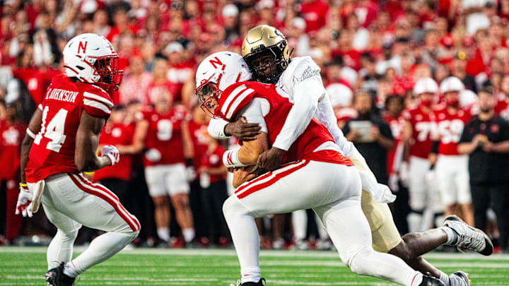 Sep 7, 2024; Lincoln, Nebraska, USA; Nebraska Cornhuskers quarterback Dylan Raiola (15) gets sacked by Colorado Buffaloes defensive end Samuel Okunlola (93) during the second quarter at Memorial Stadium. Mandatory Credit: Dylan Widger-Imagn Images